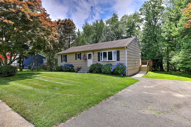 55 Mary Ellen Dr, Milford, CT 06460 - view of front facade with a front yard, a shingled roof, and view of scattered trees