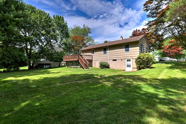 55 Mary Ellen Dr, Milford, CT 06460 - back of property featuring stairs, a wooden deck, a lawn, and a chimney