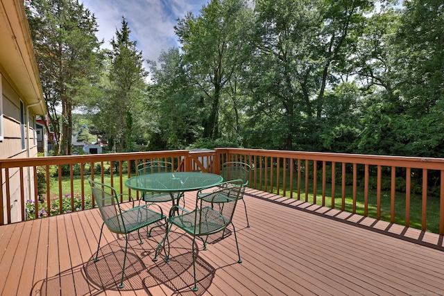 55 Mary Ellen Dr, Milford, CT 06460 - wooden deck with outdoor dining area and a lawn