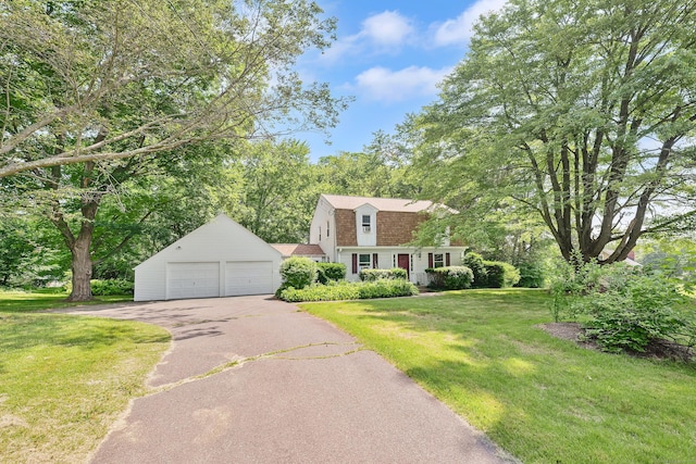 108 Pilgrim Dr, Windsor, CT 06095 - colonial inspired home featuring a gambrel roof, a front lawn, asphalt driveway, a shingled roof, and an attached garage
