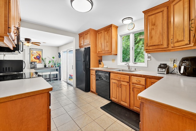 108 Pilgrim Dr, Windsor, CT 06095 - kitchen with black appliances, light tile patterned flooring, brown cabinetry, and light countertops