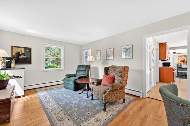 108 Pilgrim Dr, Windsor, CT 06095 - living area featuring a baseboard radiator, baseboard heating, and light wood-type flooring