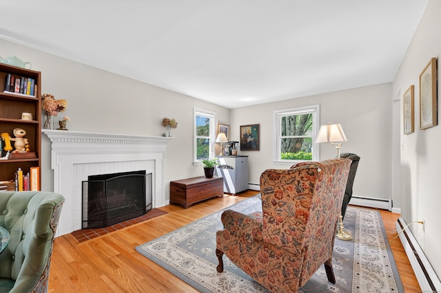 108 Pilgrim Dr, Windsor, CT 06095 - living area with baseboard heating, wood finished floors, and a fireplace