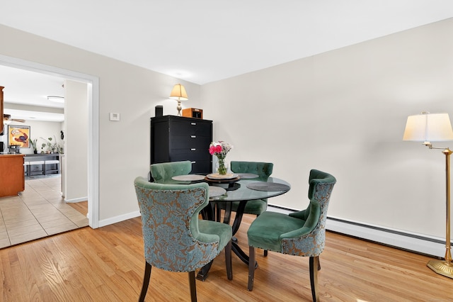 108 Pilgrim Dr, Windsor, CT 06095 - dining room with a baseboard heating unit and light wood-style floors