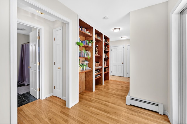 108 Pilgrim Dr, Windsor, CT 06095 - corridor featuring a baseboard heating unit and light wood-style floors