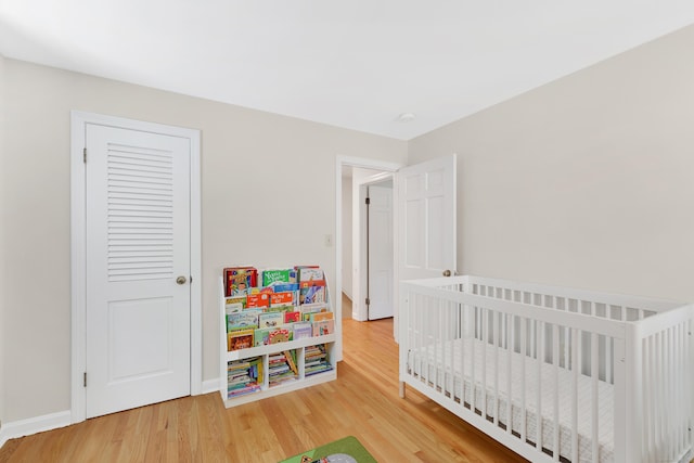 108 Pilgrim Dr, Windsor, CT 06095 - bedroom featuring wood finished floors and a crib