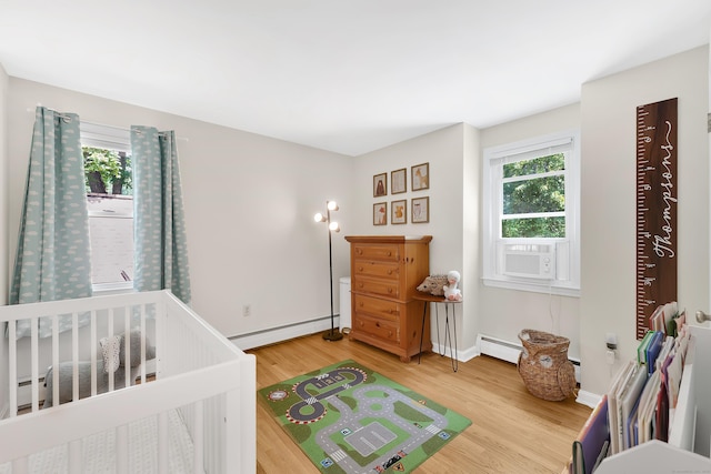 108 Pilgrim Dr, Windsor, CT 06095 - bedroom with baseboard heating, multiple windows, light wood-style flooring, and a baseboard heating unit