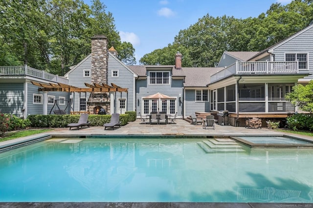 47 Tubbs Spring Dr, Weston, CT 06883 - view of pool with a patio, a pool with connected hot tub, a sunroom, and outdoor dining area
