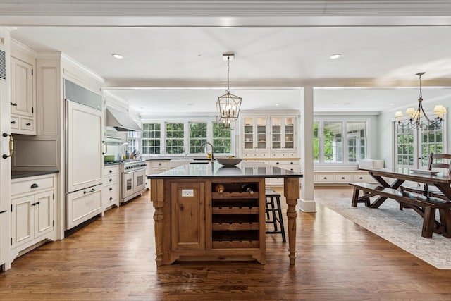 47 Tubbs Spring Dr, Weston, CT 06883 - kitchen with premium appliances, a chandelier, dark countertops, dark wood-type flooring, and crown molding