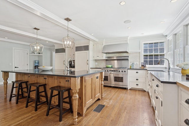 47 Tubbs Spring Dr, Weston, CT 06883 - kitchen featuring double oven range, premium range hood, dark countertops, light wood-style flooring, and crown molding