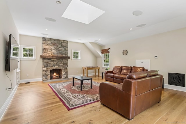 47 Tubbs Spring Dr, Weston, CT 06883 - living area featuring light wood-style floors, a stone fireplace, and a skylight