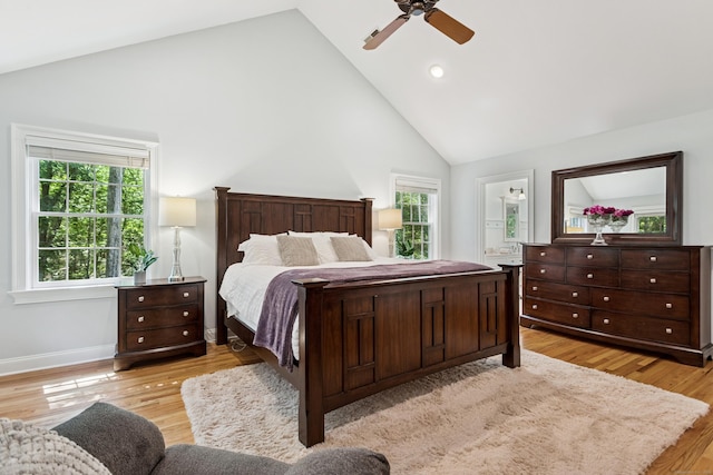 47 Tubbs Spring Dr, Weston, CT 06883 - bedroom with high vaulted ceiling, multiple windows, light wood finished floors, ensuite bath, and a ceiling fan