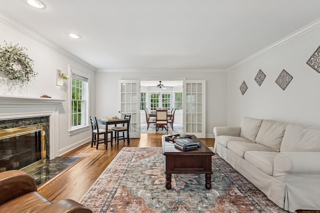47 Tubbs Spring Dr, Weston, CT 06883 - living area with ceiling fan, ornamental molding, wood finished floors, a high end fireplace, and french doors