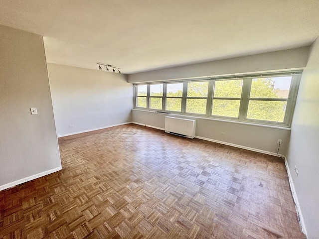 31 Woodland St Unit 7F, Hartford, CT 06103 - empty room featuring radiator and rail lighting