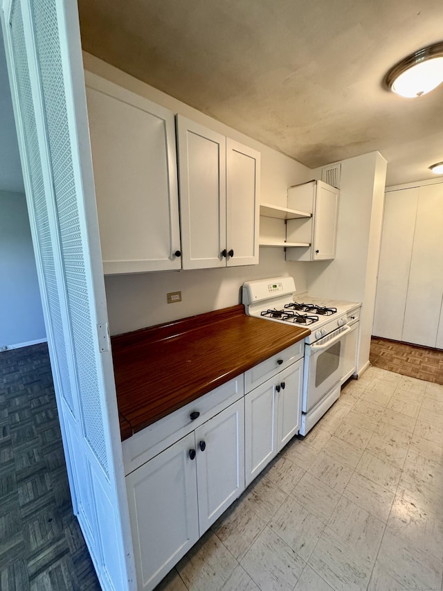 31 Woodland St Unit 7F, Hartford, CT 06103 - kitchen featuring white range with gas cooktop, butcher block counters, open shelves, and white cabinets