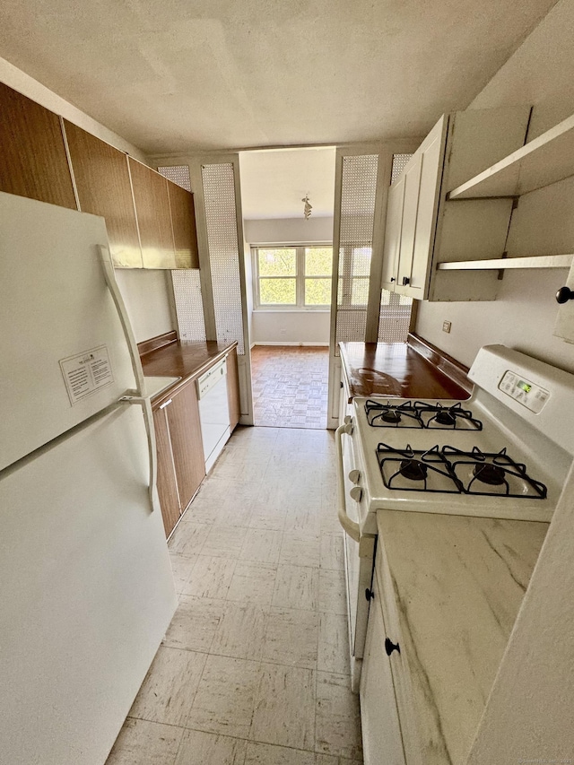 31 Woodland St Unit 7F, Hartford, CT 06103 - kitchen featuring white appliances, light floors, a textured ceiling, open shelves, and light countertops