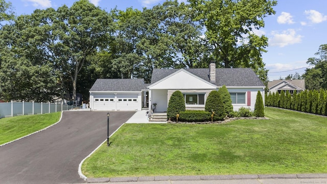 5 Greenfield Dr, Ansonia, CT 06401 - view of front of home featuring an attached garage, asphalt driveway, and a chimney