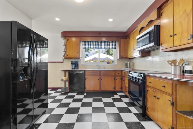 5 Greenfield Dr, Ansonia, CT 06401 - kitchen with black appliances, dark flooring, light countertops, brown cabinetry, and backsplash
