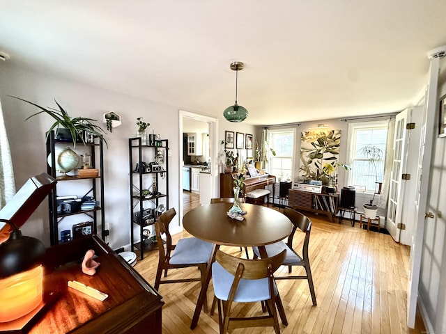 28 Grand St, New London, CT 06320 - dining room with light wood-type flooring and a baseboard heating unit