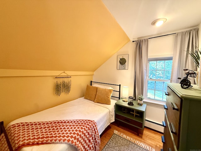 28 Grand St, New London, CT 06320 - bedroom featuring baseboard heating, wood finished floors, and vaulted ceiling