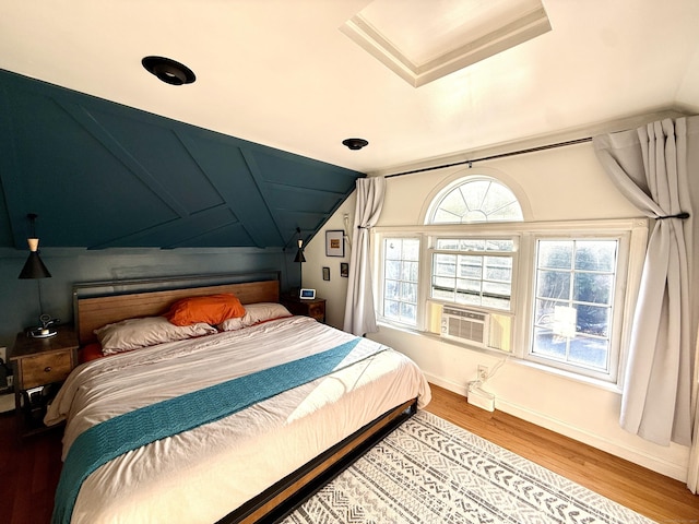 28 Grand St, New London, CT 06320 - bedroom with lofted ceiling, wood finished floors, and cooling unit