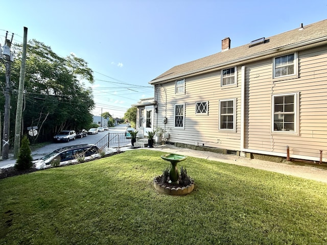 28 Grand St, New London, CT 06320 - back of property featuring a lawn and a chimney