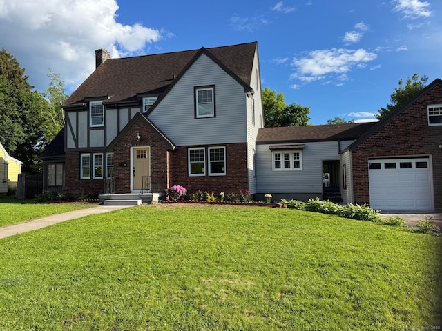 108 Adams St, New Britain, CT 06052 - english style home featuring a chimney, a front yard, brick siding, an attached garage, and roof with shingles