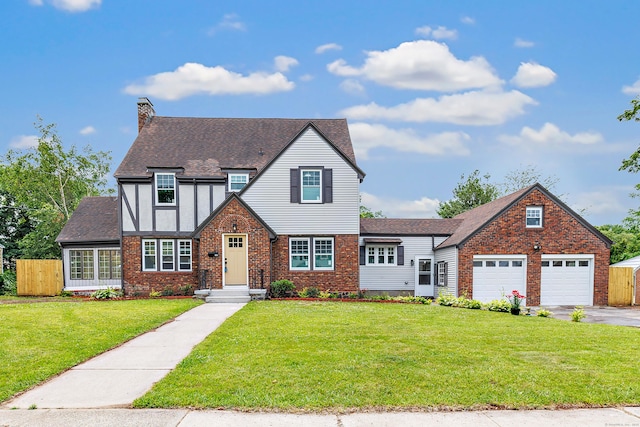 108 Adams St, New Britain, CT 06052 - tudor home featuring a chimney, asphalt driveway, brick siding, board and batten siding, and roof with shingles