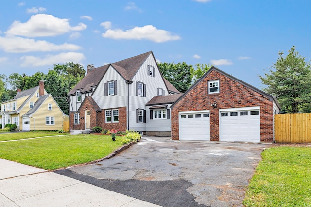 108 Adams St, New Britain, CT 06052 - view of front of house featuring asphalt driveway, an attached garage, brick siding, and a chimney