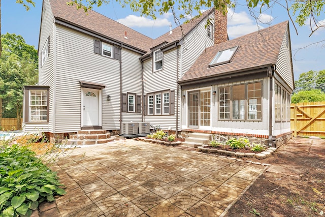 108 Adams St, New Britain, CT 06052 - rear view of property with entry steps, a patio, a chimney, and a shingled roof