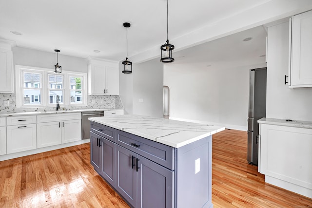 108 Adams St, New Britain, CT 06052 - kitchen with stainless steel appliances, light wood finished floors, decorative backsplash, white cabinets, and gray cabinets