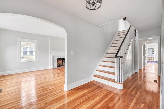 108 Adams St, New Britain, CT 06052 - stairs with arched walkways, wood finished floors, and a premium fireplace