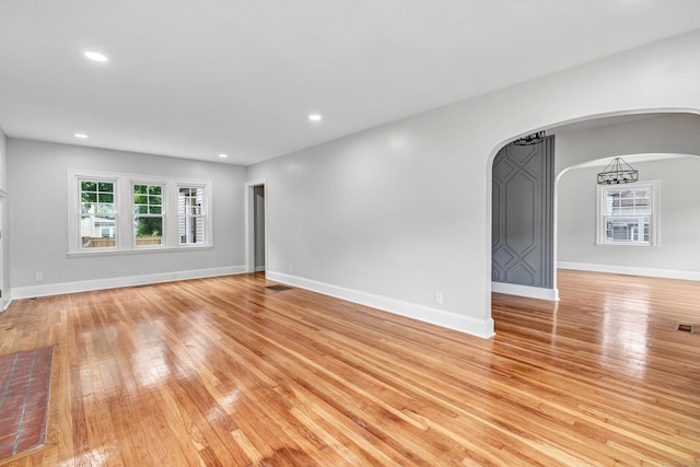 108 Adams St, New Britain, CT 06052 - empty room with arched walkways, light wood-style floors, and recessed lighting