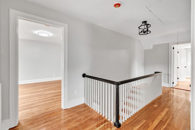 108 Adams St, New Britain, CT 06052 - hallway featuring attic access, wood finished floors, and an upstairs landing