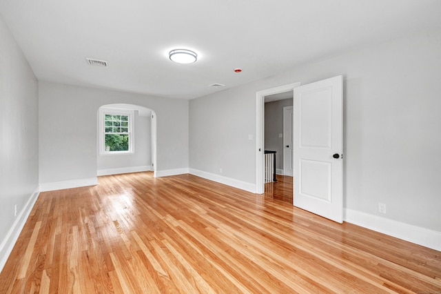 108 Adams St, New Britain, CT 06052 - empty room featuring arched walkways and light wood-style floors