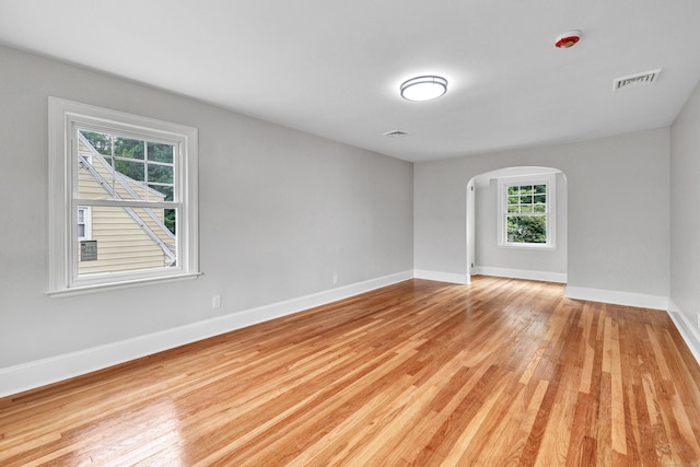 108 Adams St, New Britain, CT 06052 - spare room with light wood finished floors and arched walkways