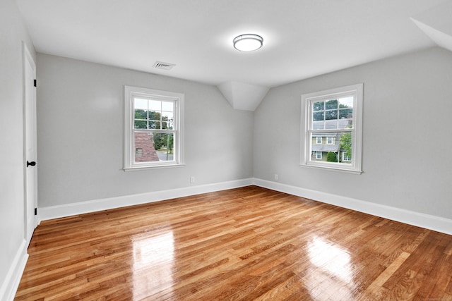 108 Adams St, New Britain, CT 06052 - spare room with healthy amount of natural light, lofted ceiling, and wood finished floors