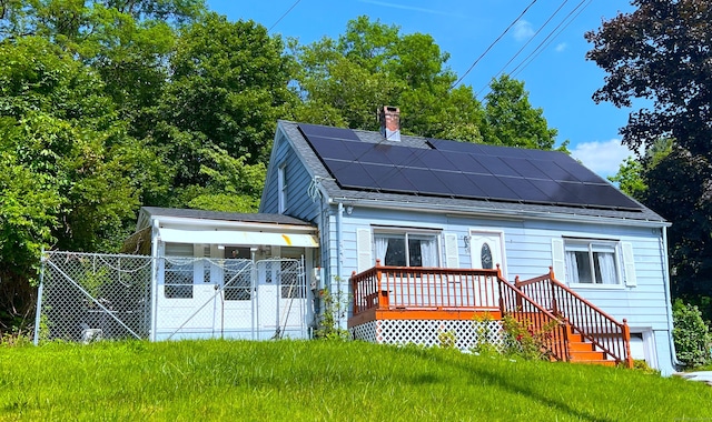 30 Roulin St, Torrington, CT 06790 - rear view of house with roof mounted solar panels and a chimney