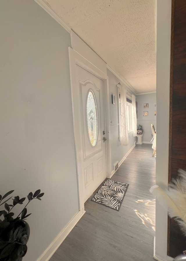 30 Roulin St, Torrington, CT 06790 - foyer entrance with wood finished floors, crown molding, and a textured ceiling