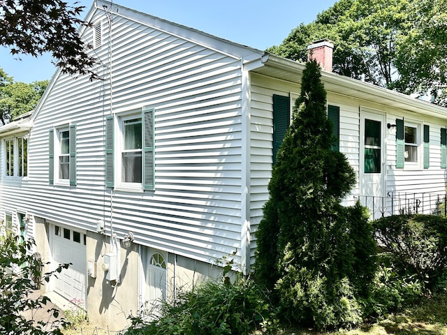 191 Prospect Hill Rd, Groton, CT 06340 - view of side of home with a chimney and an attached garage
