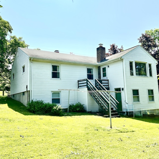 191 Prospect Hill Rd, Groton, CT 06340 - back of property featuring a chimney, a lawn, and stairs