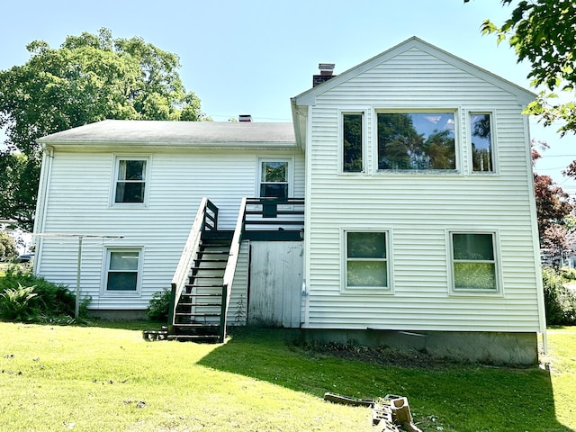 191 Prospect Hill Rd, Groton, CT 06340 - back of property featuring stairs, a lawn, a chimney, and a deck