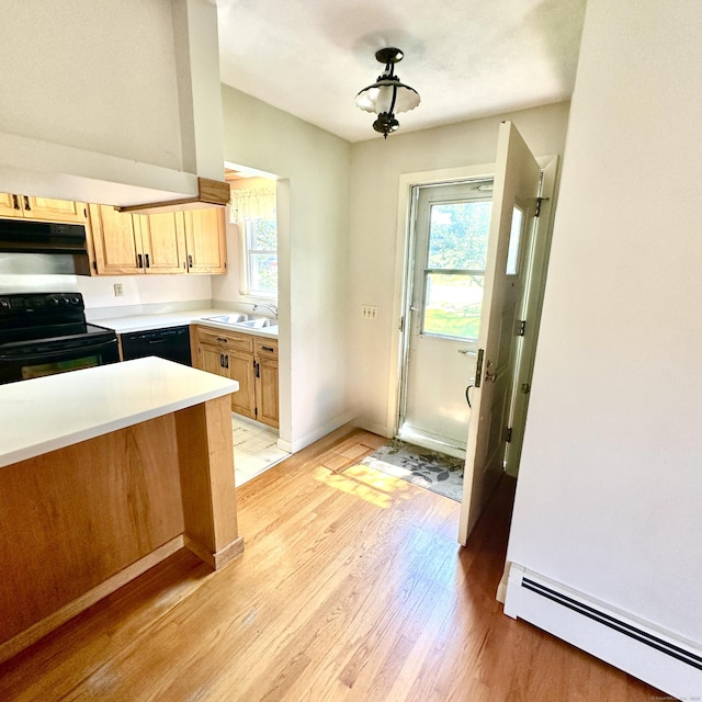 191 Prospect Hill Rd, Groton, CT 06340 - kitchen featuring black appliances, a baseboard radiator, light wood-type flooring, light countertops, and light brown cabinetry