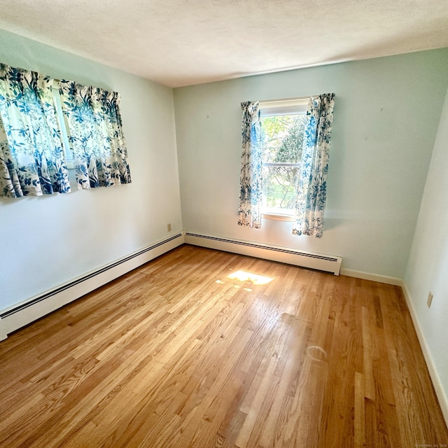 191 Prospect Hill Rd, Groton, CT 06340 - unfurnished room with a baseboard heating unit and wood finished floors