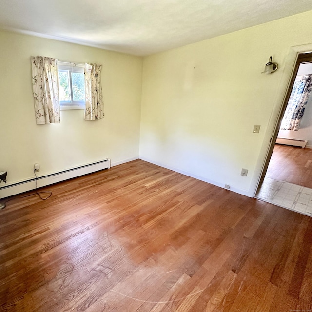 191 Prospect Hill Rd, Groton, CT 06340 - empty room with a baseboard radiator and wood finished floors