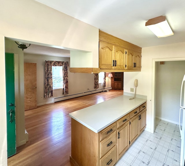 191 Prospect Hill Rd, Groton, CT 06340 - kitchen featuring baseboard heating, light countertops, a peninsula, light wood-style floors, and freestanding refrigerator