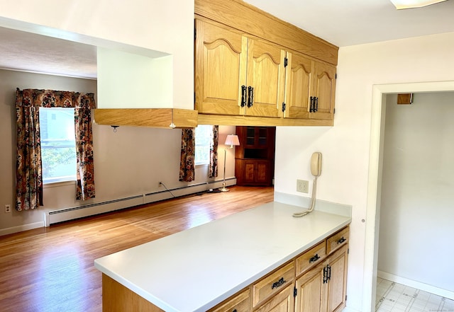 191 Prospect Hill Rd, Groton, CT 06340 - kitchen featuring a baseboard radiator, light countertops, light wood-style flooring, and a peninsula