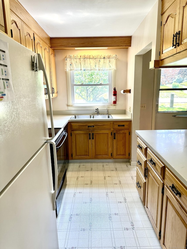 191 Prospect Hill Rd, Groton, CT 06340 - kitchen with freestanding refrigerator, light flooring, light countertops, and black / electric stove