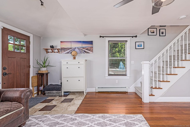 8 Johnson St, Stonington, CT 06379 - entrance foyer with baseboard heating, stairway, wood finished floors, and ceiling fan
