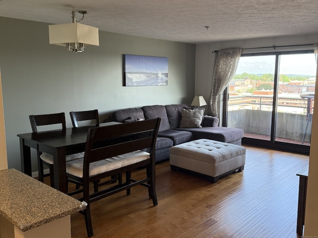 111 Dekoven Dr Apt 1008, Middletown, CT 06457 - living area featuring a chandelier, a textured ceiling, and wood finished floors